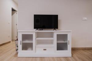 a white entertainment center with a flat screen tv on top at San Rafael 4- Parking gratuito in Córdoba