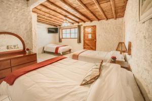 Postel nebo postele na pokoji v ubytování Hotel Fundo El Arrabal