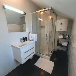 a white bathroom with a shower and a sink at Apartments Marti in Murter +52 photos