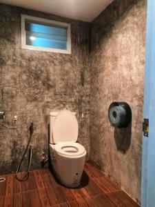 a bathroom with a toilet and a window at Backpack Hostel Kohyaoyai in Ko Yao Yai