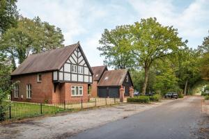 a brick house with a black and white roof at Beautiful English Villa with hottub in Zuidwolde