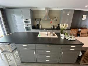 a kitchen with a kitchen island with a sink at Cosy vacation home for 8 persons in Heers +14 photos