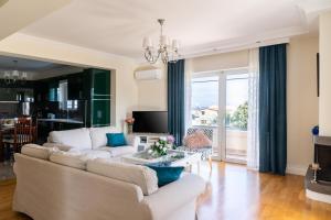 a living room with a couch and a table at Coastline maisonette near Athens Airport and Rafina Port in Artemida