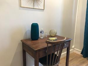 a wooden table with a blue vase on it at Logis Le Cheval Blanc in Saint-Just