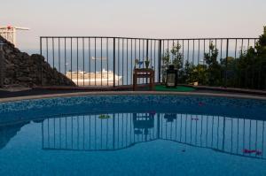a swimming pool in front of a fence at Residence Zelzar in Vietri sul Mare