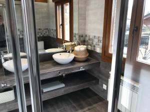 a bathroom with two sinks and two mirrors at Maison Cerdagne in Bourg-Madame +57 photos