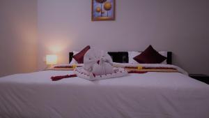 Postel nebo postele na pokoji v ubytování Hotel Akshith Inn