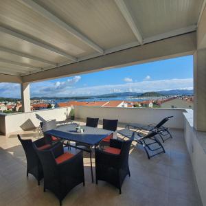 a patio with a table and chairs on a balcony at Apartments Marti in Murter +55 photos