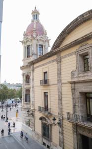 a group of people riding bikes in front of a building at Hostal Tartessos in Valencia
