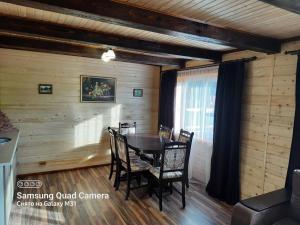 a dining room with a table and chairs at Котедж "Смерековий затишок" in Vorokhta