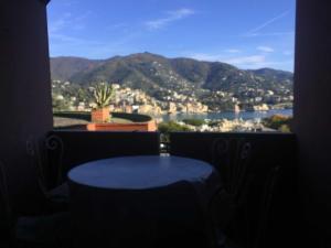 a window with a table and a view of a city at Eurotel 312 in Rapallo +20 photos