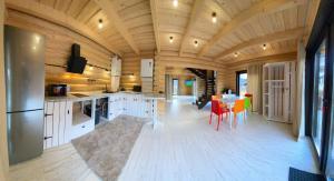 a large kitchen with a table and chairs at Guculka Apartments in Yaremche