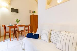 a living room with a couch and a table at Appartamento Rosa Blu PT - MyHo Casa in Torre Canne