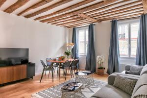 a living room with a couch and a table at 97 - Urban Colonnes de Buren in Paris