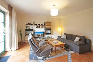 a living room with a couch and a table at Ostseetraum Wohnung EG in Wittenbeck