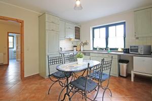 a kitchen with a table and chairs in a kitchen at Ostseetraum Wohnung EG in Wittenbeck