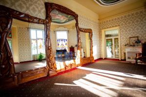 an ornate room with a large mirror in a room at Zolota Pava in Berehove