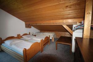 a bedroom with two beds in a wooden room at Haus Gerdi in Söll