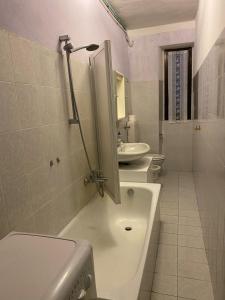 a bathroom with a sink and a toilet and a tub at Lago e Monti in Colico