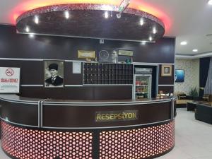 a reception area of a restaurant with a reception counter at LOTUS OTEL in Konya