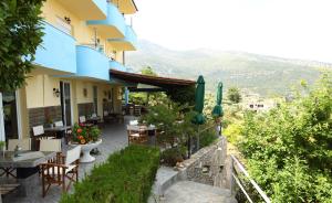 a building with a patio with tables and chairs at Haus Sofis in Koinyra