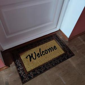 a welcome mat on the floor next to a door at Гостиница Суворов in Kobryn