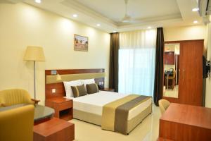 a bedroom with a bed and a desk and a chair at RED SEA HOTEL APARTMENT in Djibouti