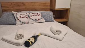 a bed with white towels and a christmas pillow at Apartman Maslacak in Divčibare