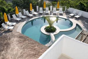 a swimming pool with chairs and a swan in the middle at Miradouro de São Sebastião in São Sebastião