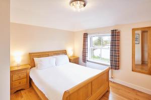a bedroom with a large bed and a window at Host & Stay - Holmedene in Filey