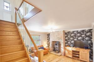 a living room with a staircase and a television at Host & Stay - Holmedene in Filey