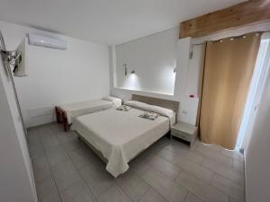 a small room with two beds in a room at Al Mare da Francesca in Olbia