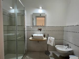 a bathroom with a sink and a glass shower at Al Mare da Francesca in Olbia