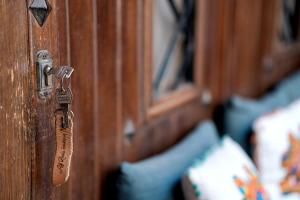 a wooden door with a key on it at Alf Leila Boutique Hotel in Dahab
