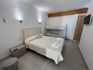 a small bedroom with a bed and a toilet at Al Mare da Francesca in Olbia