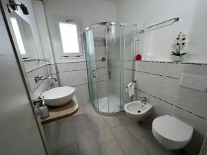 a bathroom with a shower and a toilet and a sink at Al Mare da Francesca in Olbia
