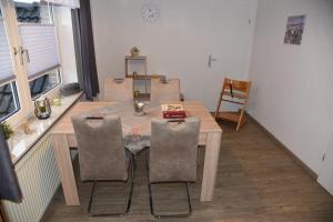 a dining room table and chairs in a room at Gästehaus Steffen in Upgant-Schott +17 photos