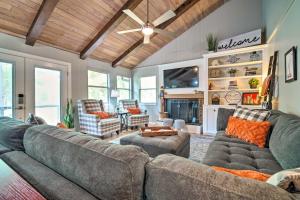 a living room with two couches and a fireplace at Cape Royale Cottage with Fire Pit and Water Views in Coldspring
