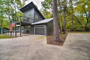 a house with a garage and a tree at Cape Royale Cottage with Fire Pit and Water Views in Coldspring