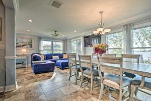 a dining room with a table and chairs and a couch at Lakefront Home with Game Room, Theater and Dock! in Fox Lake