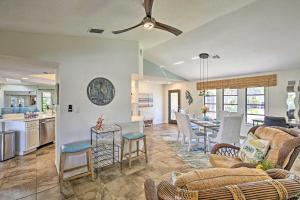 a living room and kitchen with a couch and chairs at Canal Waterfront Home with Private Pool and Dock! in Punta Gorda