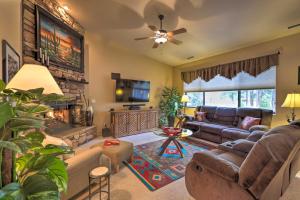 a living room with a couch and a fireplace at Vibrant Home with Patio about 60 Miles to Grand Canyon! in Williams