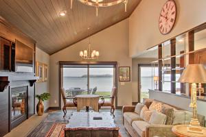 a living room with a couch and a clock on the wall at Breezy Point Escape with Views, Dock and Fire Pit! in Breezy Point