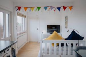 a baby room with a crib and flags on the wall at The Nook in Barnstaple