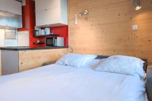 a white bed with two pillows in a room at Studio Coulet - Welkeys in LʼHuez