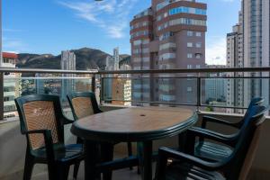 a table and chairs on a balcony with a view at Apartamento Completo Torresol IV in Benidorm