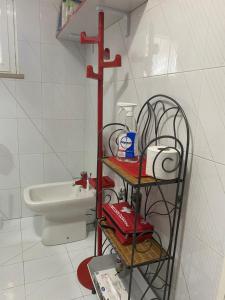 a bathroom with a toilet and a shelf with toiletries at Villa Ulivi in Tocco da Casauria +49 photos