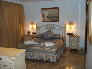 Postel nebo postele na pokoji v ubytování Hotel Hacienda Don Manuel