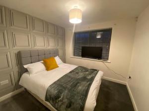 a bedroom with a bed and a window and a television at Westpoint in Derby