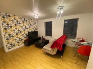 a living room with a couch and a table at Westpoint in Derby